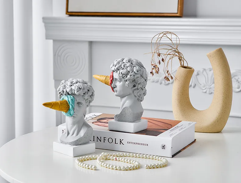 A pair of Ice Cream Smashed Face David Statues, adding a touch of whimsical charm to the sophisticated home decor ensemble, perfect for the modern connoisseur.